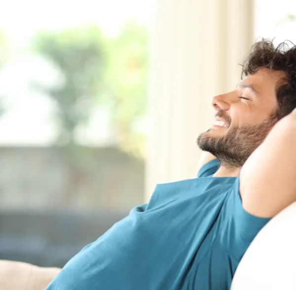 Happy handsome man resting and relaxing at home