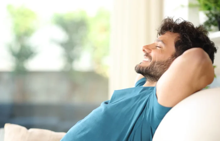 Happy handsome man resting and relaxing at home